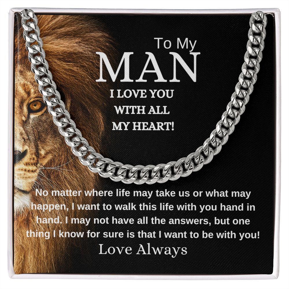 A necklace with a cuban link chain design, presented in a box with black background with face of lion a message card to a man expressing love.