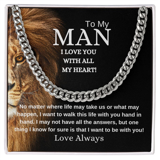 A necklace with a cuban link chain design, presented in a box with black background with face of lion a message card to a man expressing love.